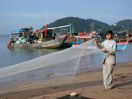 Vietnam, Hong Chong (Mekong Delta), December 2003.
Fisher woman.
Vietnamese fisher woman is drying the fishing nets. 
